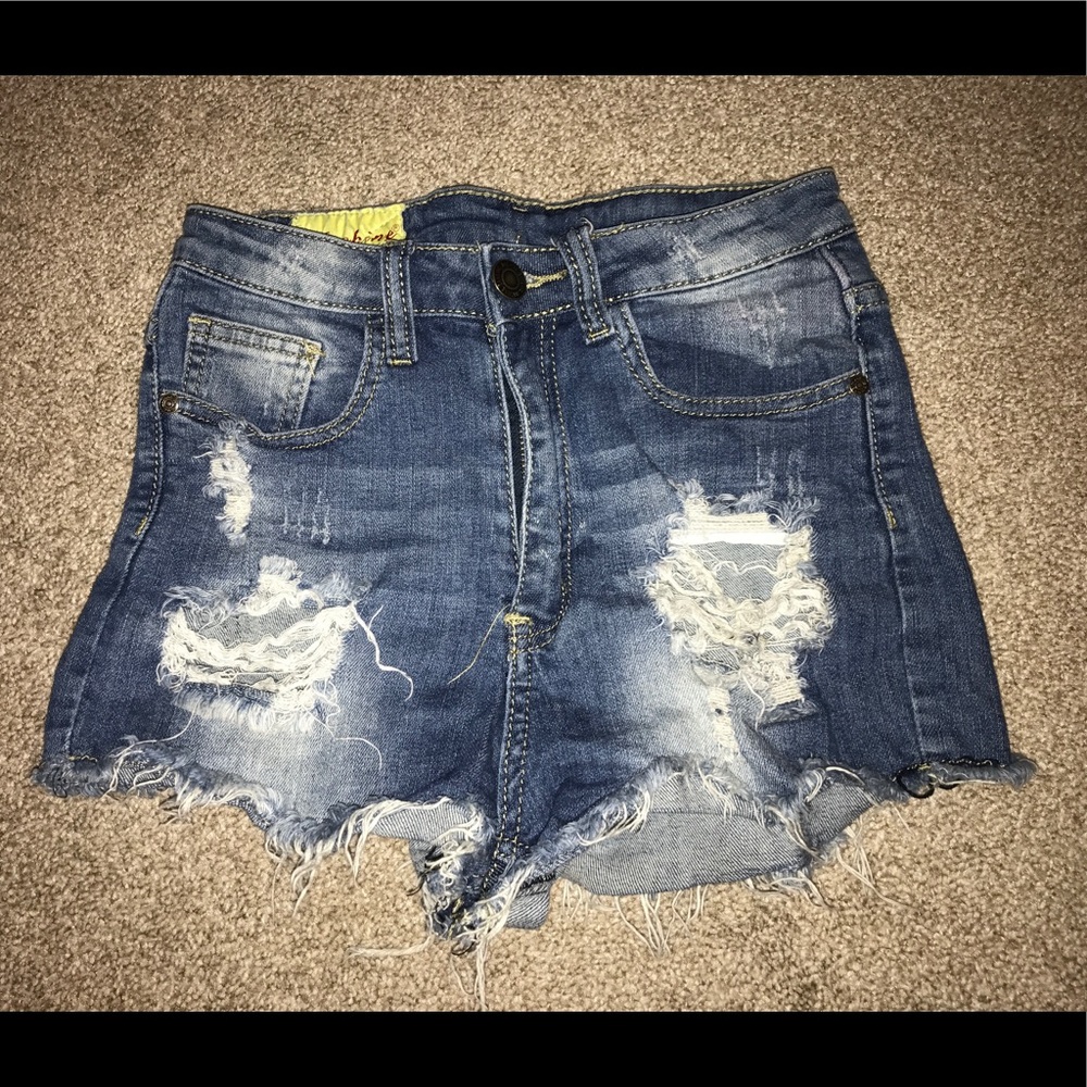 Jean shorts with holes.